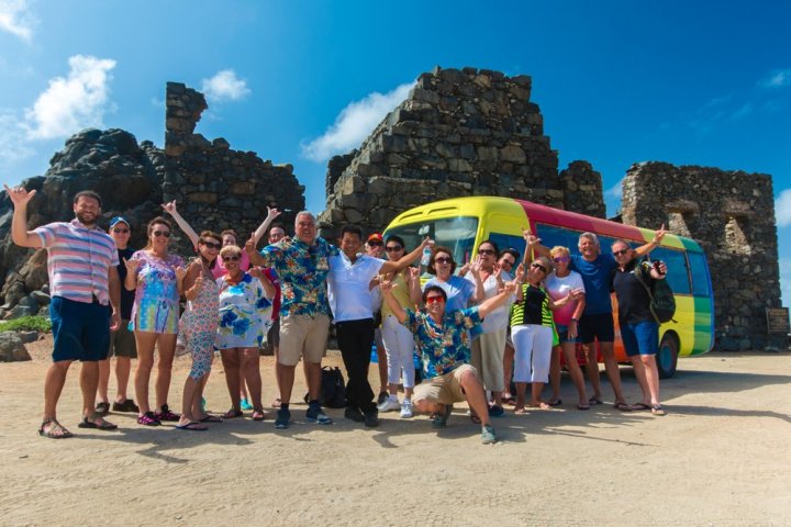 a group of people on a beach posing for the camera