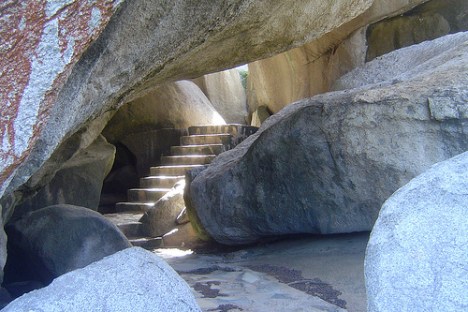 Stone steps leading through large boulders in a natural rock formation.
